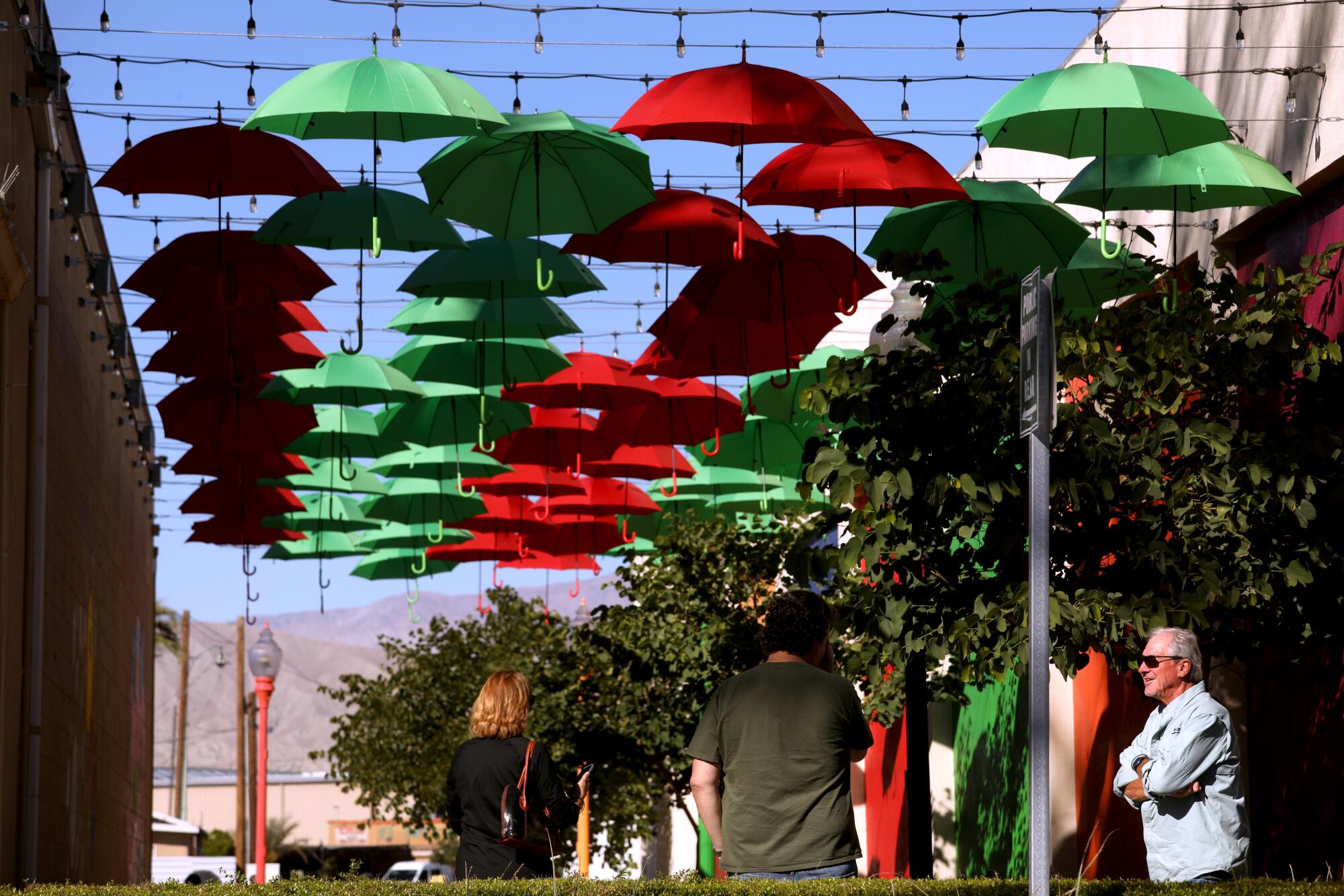 People enjoy an art installation in downtown Indio.