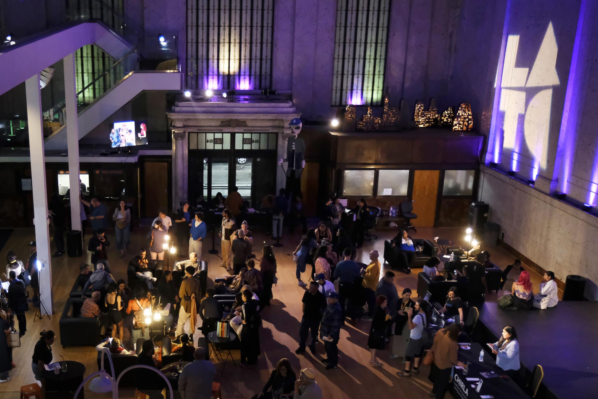 People stand in the lobby of the Los Angeles Theatre Center in downtown Los Angeles