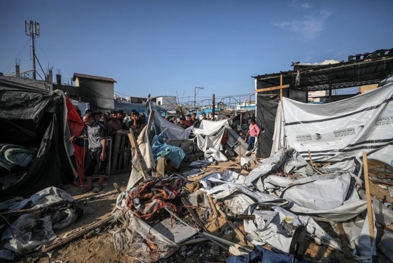 Gazans inspect their damaged shelters following an Israeli airstrike inside the Al Aqsa Martyrs Hospital compound in Deir Al Balah, central Gaza Strip, on Saturday. Photo by Mohammed Saber/EPA-EFE