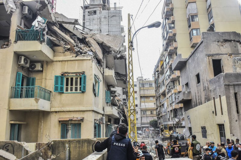 Residents and rescuers gather in front of a building targeted by an Israeli strike in Beirut's Ras al-Nabaa neighborhood, on Sunday, November 17, 2024. Photo by Rahim Rhéa/UPI