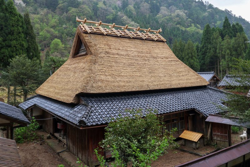 This is a traditional Japanese kominka farmhouse in the countryside of Kyoto. These structures implement centuries of traditional design and building techniques and are constructed from natural materials. Photo by David Caprara