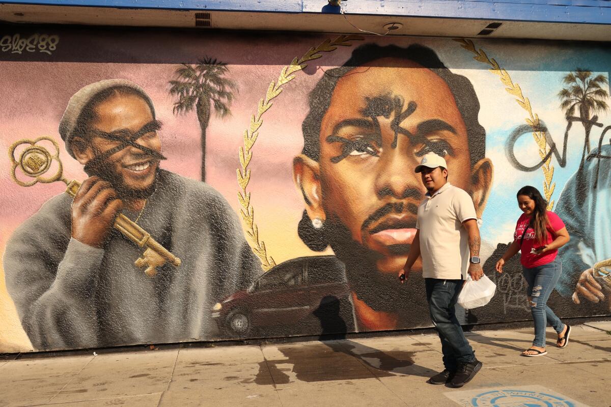 A defaced mural of Kendrick Lamar 