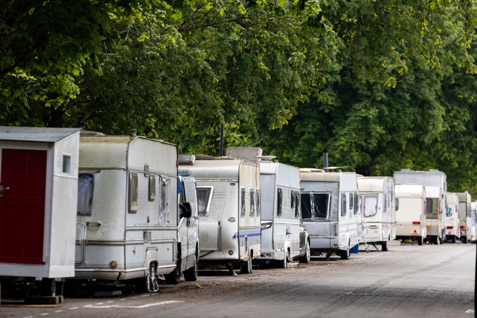 Vans and caravans line a street near St George's Park, Bristol