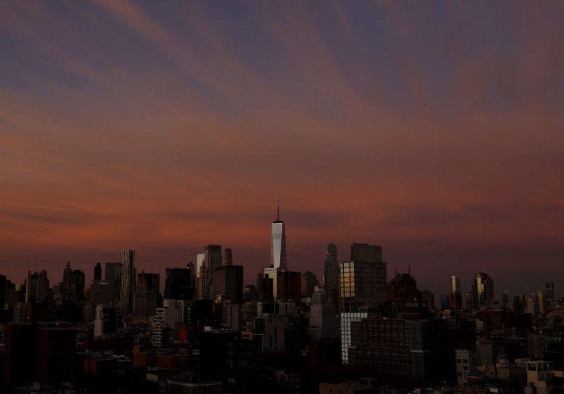 The sky Is lit in red, orange and blue colors behind One World Trade Center and the Manhattan Skyline just before sunrise in New York City on Thursday. New York City Mayor Eric Adams elevated the city's drought watch to a warning on Monday. Photo by John Angelillo/UPI