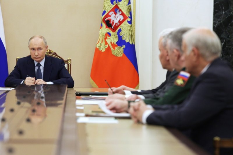 Russian President Vladimir Putin (L) holds a meeting with the Defense Ministry leadership and representatives of the defense industry in Moscow on Friday. Putin announced he had ordered serial production of the Oreshnik hypersonic missile a day after it was used against a Ukrainian aerospace facility. Kremlin Pool Photo by Gavriil Grigorov/EPA-EFE