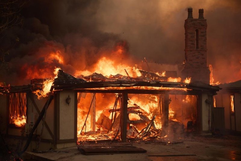 A mansion goes up in flames as the Mountain Fire burns Wednesday in Camarillo, California. The fire, which is being fueled by powerful Santa Ana winds, has burned an estimated 9,000 acres and destroyed dozens of homes. Photo by Allison Dinner/EPA-EFE