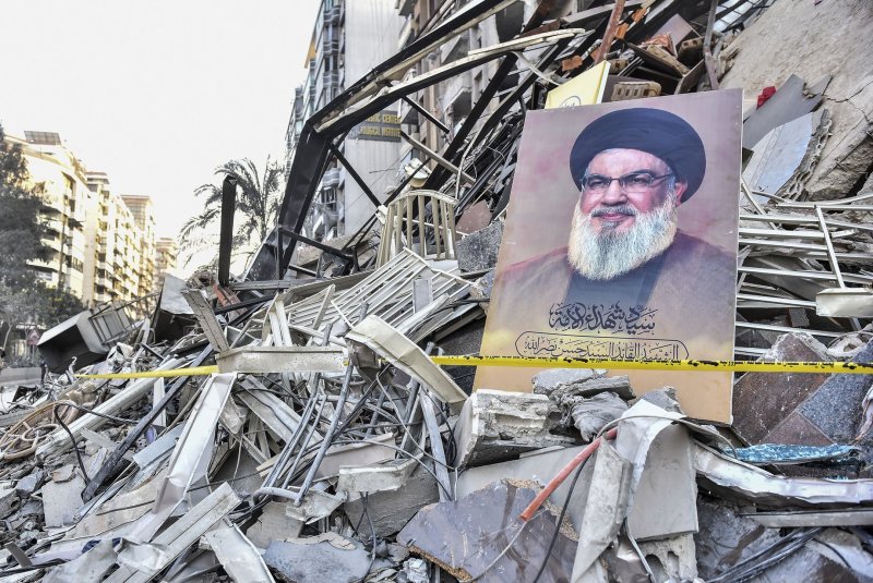 A portrait of slain Hezbollah chief Hassan Nasrallah lies in front of the rubble of a building at the site of an Israeli airstrike in Beirut, Lebanon's southern suburbs on Thursday. Photo by Fadel Itani/UPI