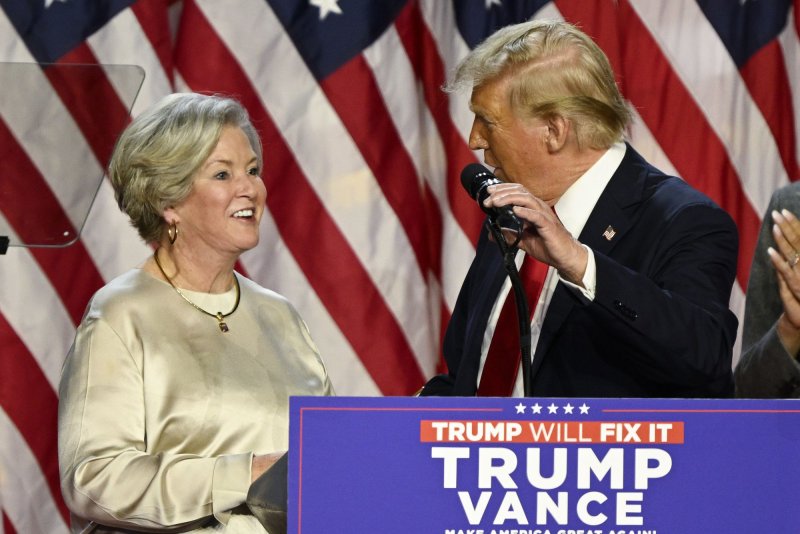 President-elect Donald Trump invites his campaign manager Susie Wiles to the podium when he delivers a speech from the Palm Beach Convention Center at the Trump Campaign Election Night Watch Party on Wednesday. Trump has named Wiles chief of staff, the first woman to hold the post. Photo by Joe Marino/UPI