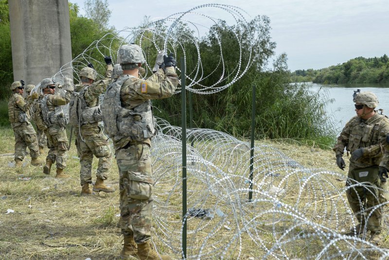 Soldiers from the 97th Military Police Brigade and the 41st Engineering Company from Fort Riley, Kan., work alongside U.S. Customs and Border Protection officers at the Hidalgo, Texas, port of entry in 2018. Recently, some state and local officials, such as Denver Mayor Mike Johnston, have said they'll resist deportation efforts that will be carried out by the U.S. military. File Photo by Senior Airman Alexandra Minor/U.S. Air Force/UPI