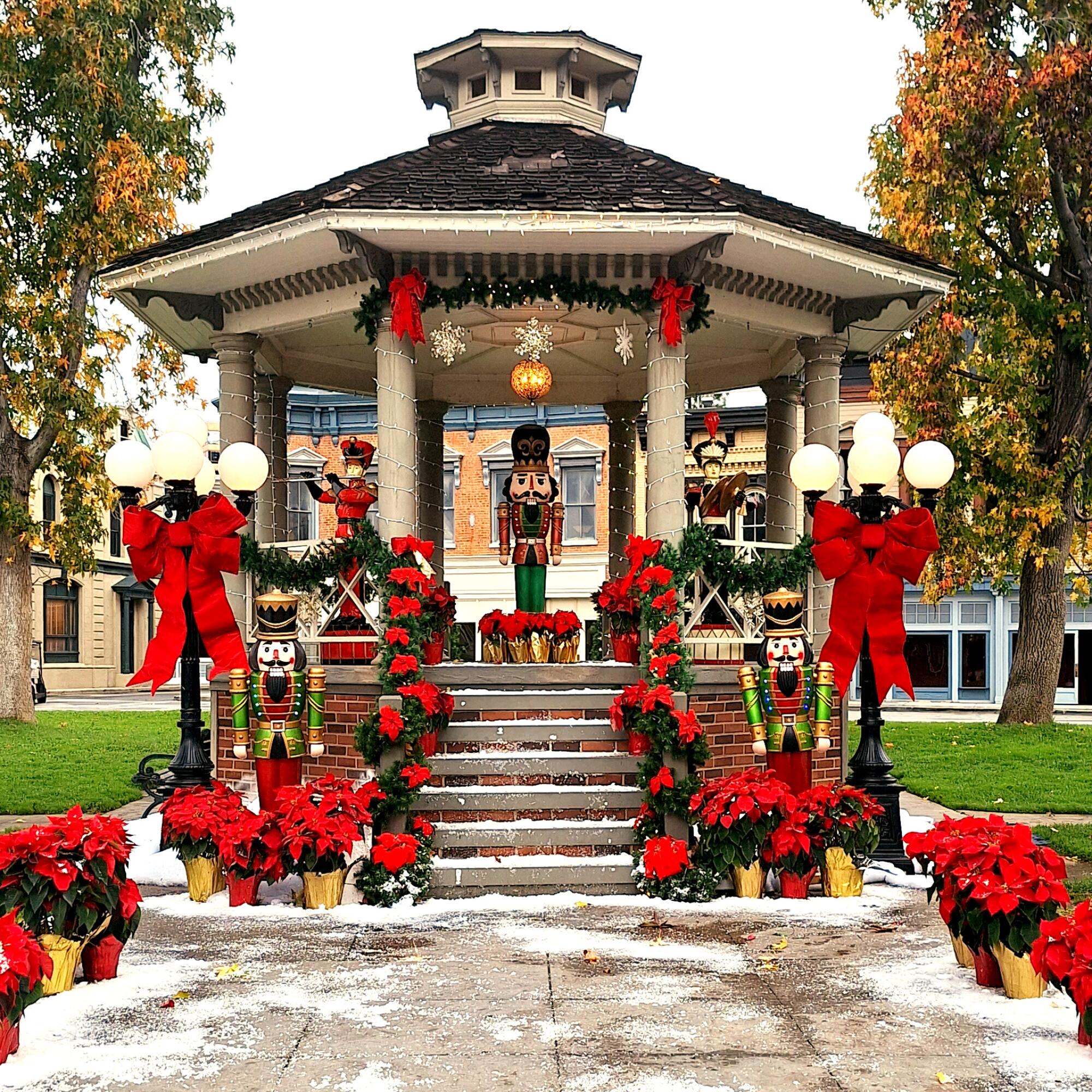 A backlot gazebo with a large nutcracker figurine in its center. 