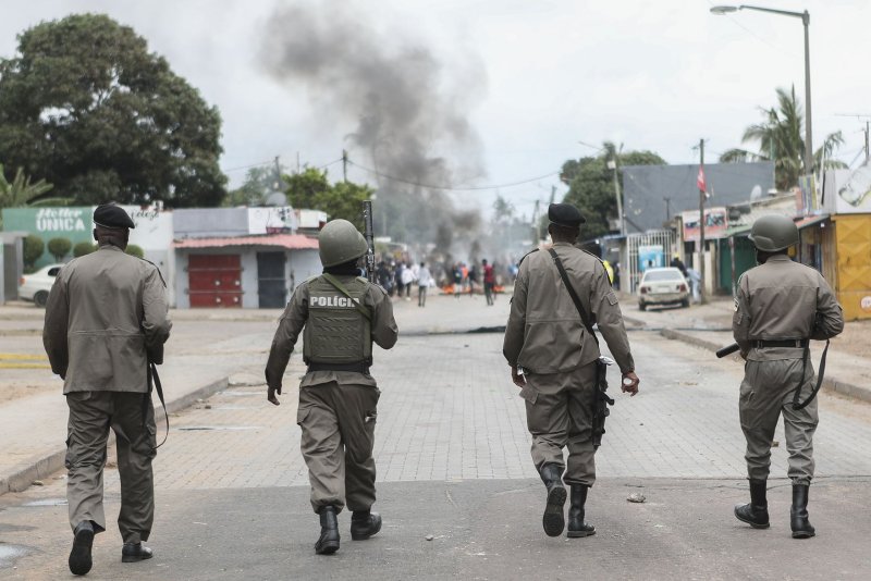 Members of Mozambican police walk as they disperse people gathering to take part in the peaceful marches called by presidential candidate Venancio Mondlane to repudiate the murder of two supporters, in Maputo, Mozambique, last month. Many of the migrants working illegally in abandoned South African gold mines have fled Mozambique. Photo by Luisa Nhantumbo/EPA-EFE