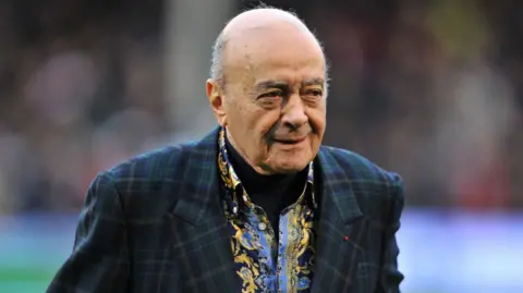 PA Media Al Fayed wearing a green blazer