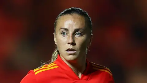 Getty Images Wales player Natasha Harding, now known as Allen-Wyatt, is wearing a Wales football shirt