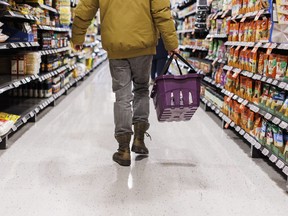 The latest inflation reading out Tuesday from Statistics Canada is expected to show a slight uptick but economists say the measure is still on a longer-term downward trend. A customer browses an aisle at a grocery store In Toronto on Friday, Feb. 2, 2024.