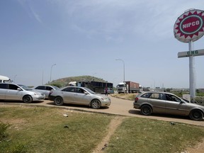 Cars and trucks wait to buy Compressed Natural Gas (CNG) at a filling station in Abuja, Nigeria, Thursday, Nov. 7, 2024.