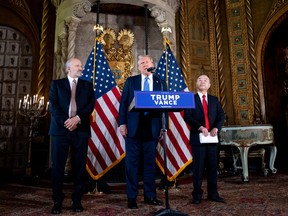 U.S. President-elect Donald Trump, accompanied by SoftBank CEO Masayoshi Son (R) and Trump's choice for Secretary of Commerce, Cantor Fitzgerald Chairman and CEO Howard Lutnick, speaks at a news conference at Trump's Mar-a-Lago resort on December 16, 2024 in Palm Beach, Fla.