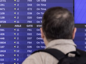 A traveller looks at Air Canada flight times at Toronto Pearson Airport Terminal 1 on Aug. 30, 2024.