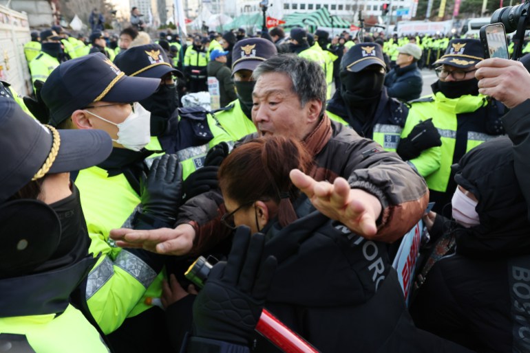 Protesters clash with police officers during a demonstration calling for the resignation and impeachment of South Korean President Yoon Suk Yeol 