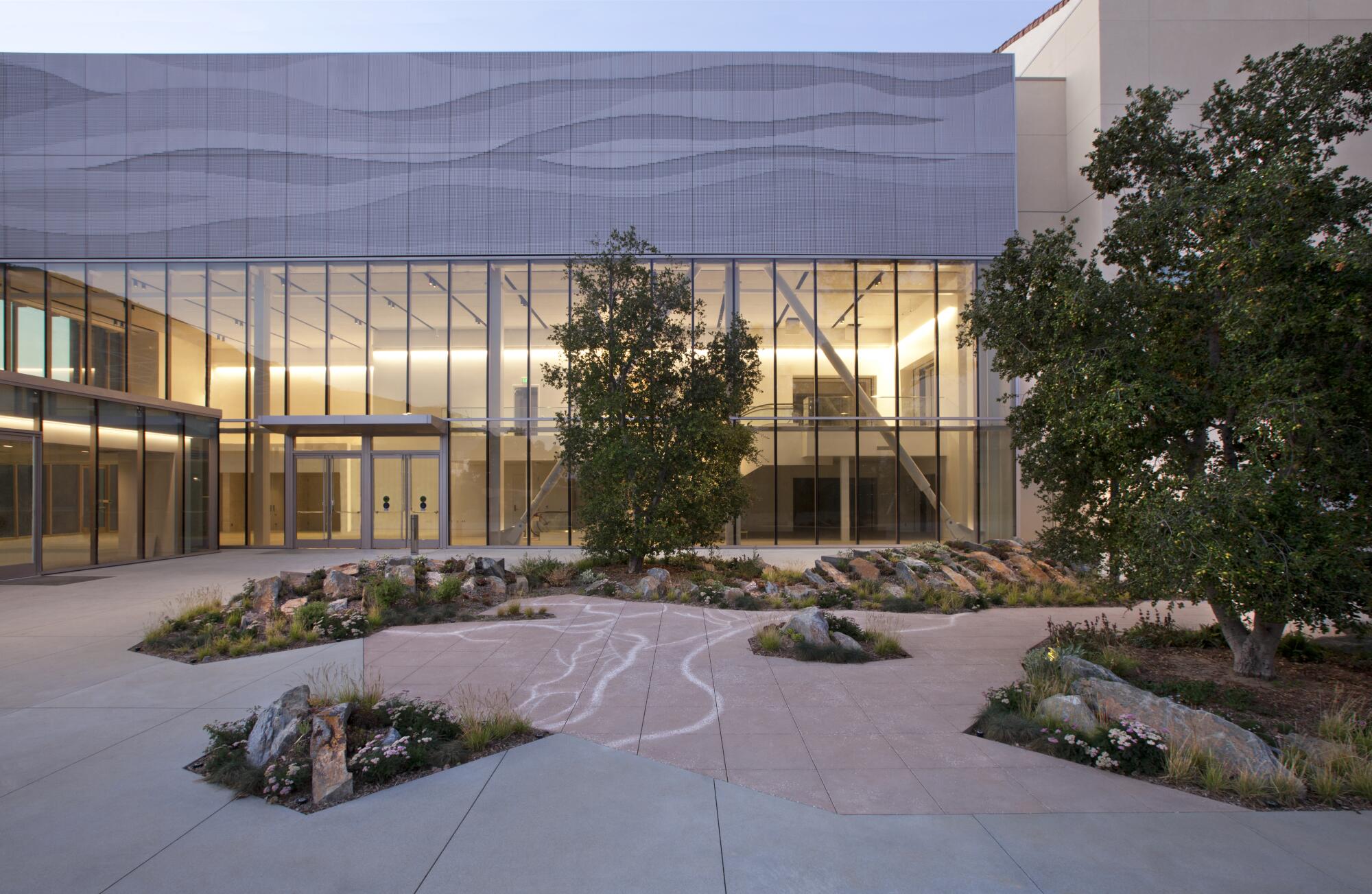 The new NHM Commons at the Natural History Museum, with its glass exterior and native plantings.