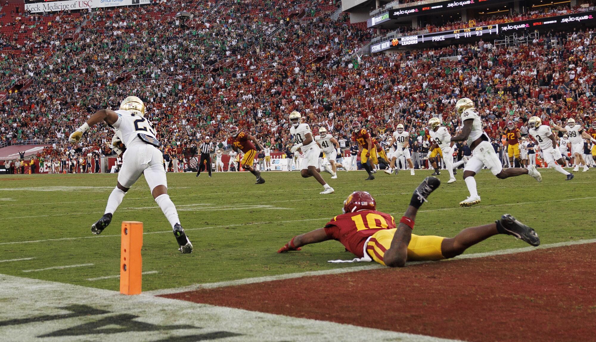 Notre Dame cornerback Christian Gray intercepts a pass intended for USC receiver Kyron Hudson at the goal line.