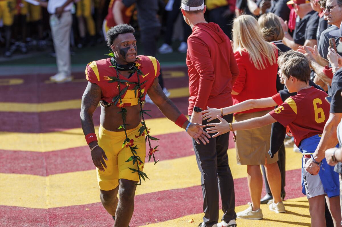 Woody Marks gets hand slaps from fans before his last home game during senior introductions against Notre Dame.