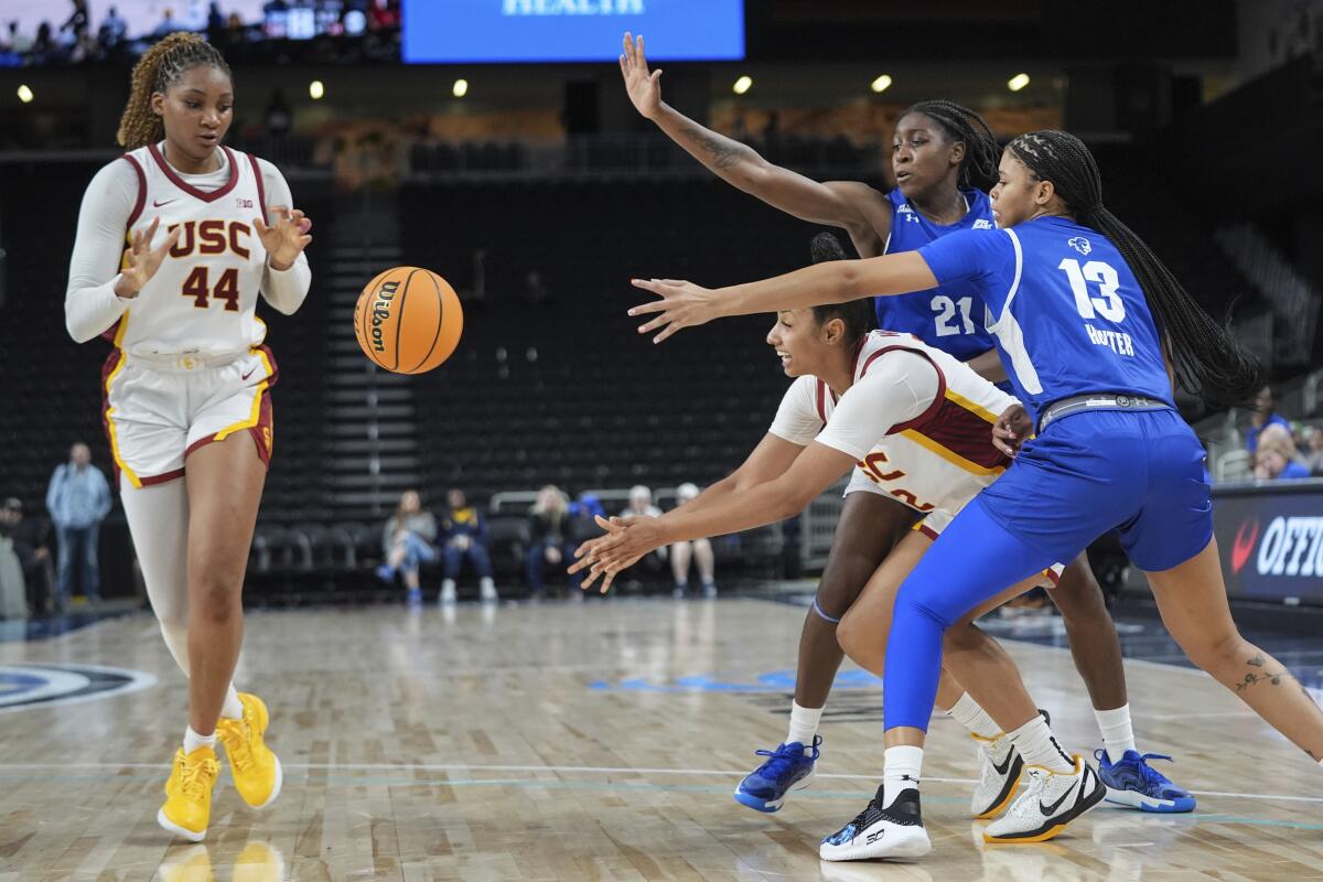 JuJu Watkins passes the ball to Kiki Iriafen as she is defended by two Seton Hall players.