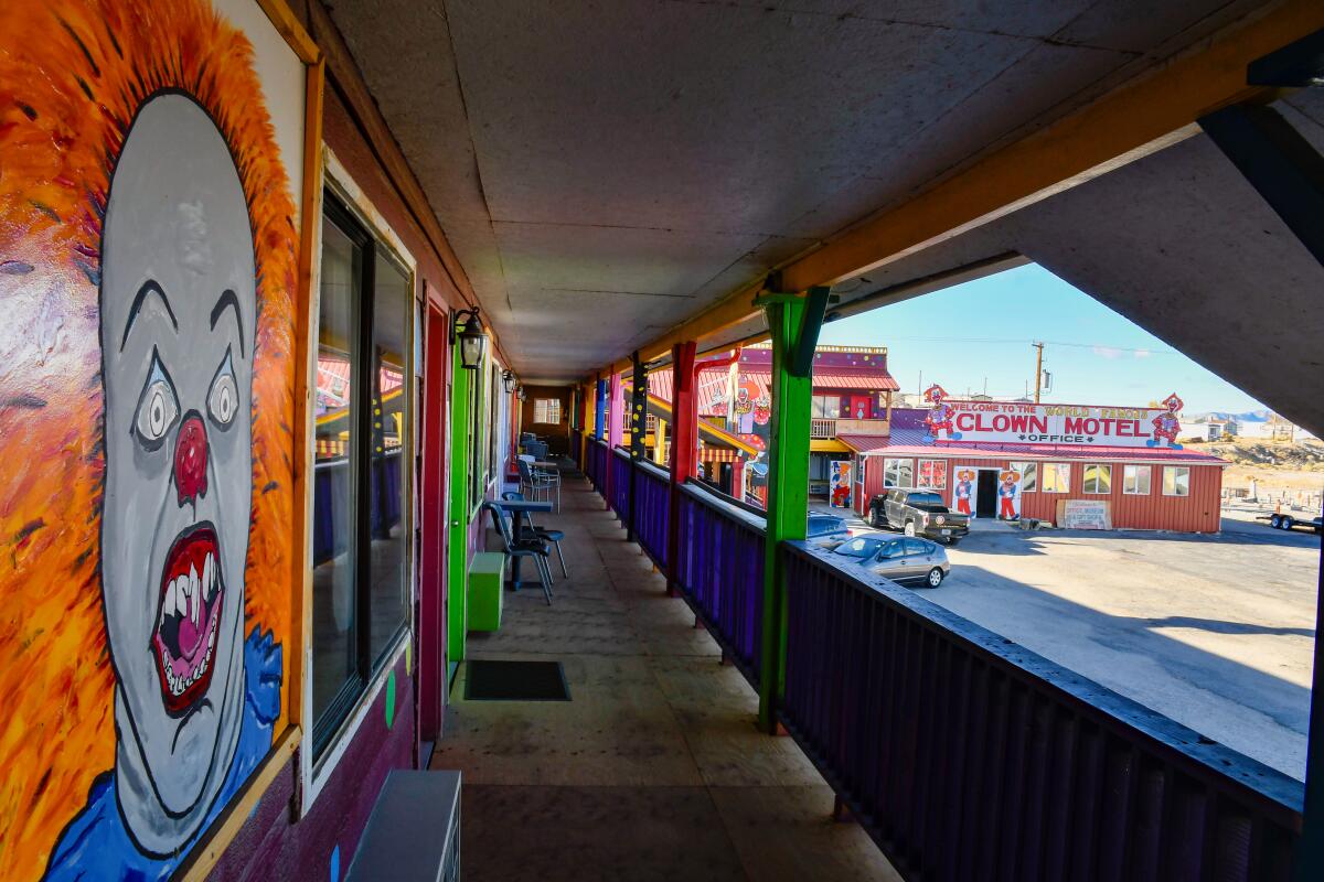 A portrait of an evil clown is painted on the wall next to the motel rooms at the Clown Motel.