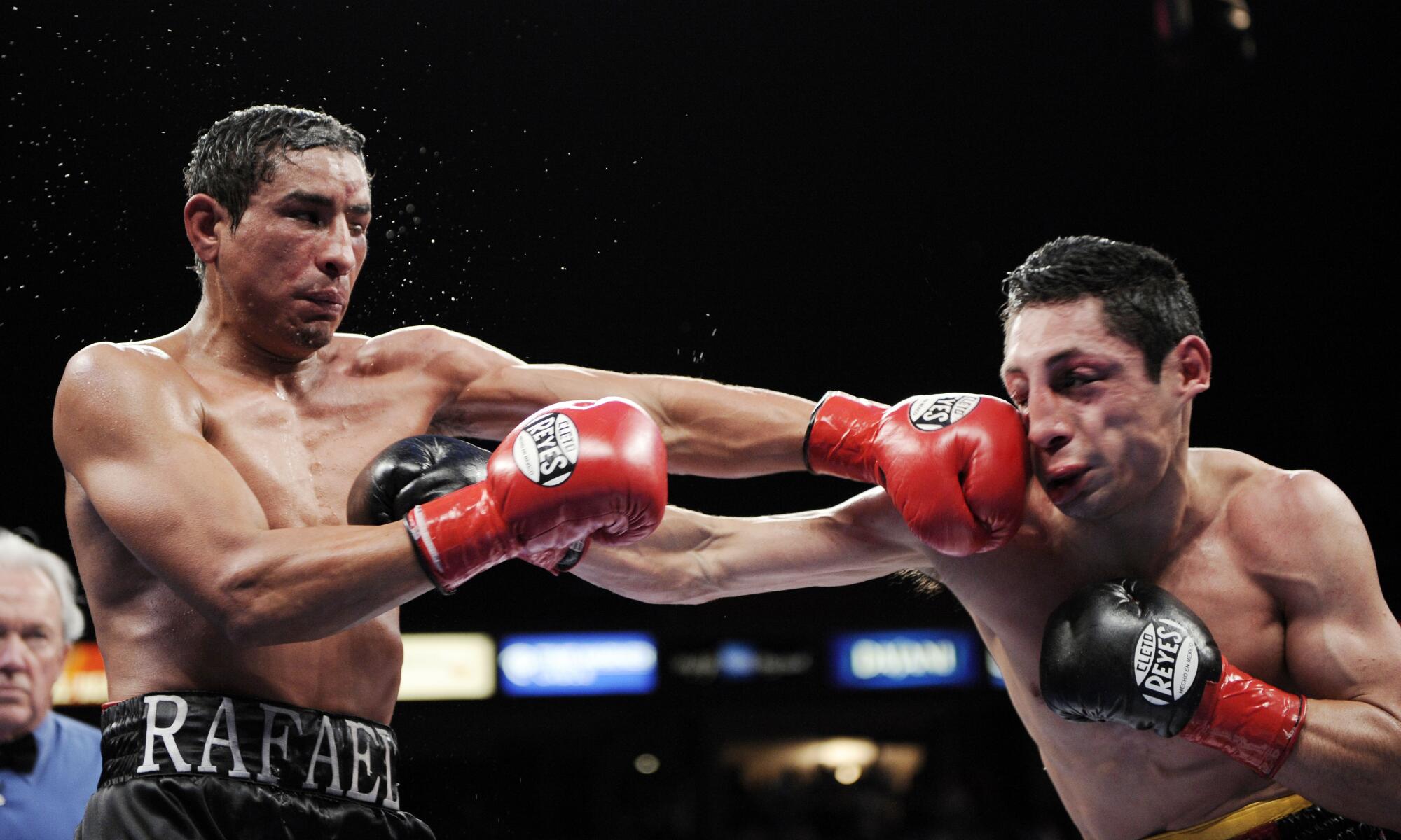 Rafael Márquez, left, connects with Israel Vázquez during their WBC super bantamweight championship bout