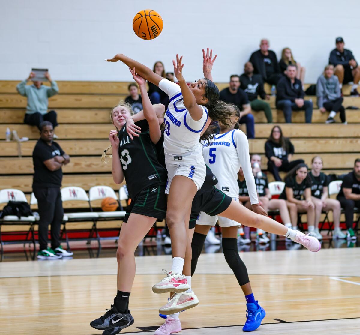 Freshman Shiloh Johnson of Windward (13) gets physical in a battle for the ball during a game against against Sage Hill.