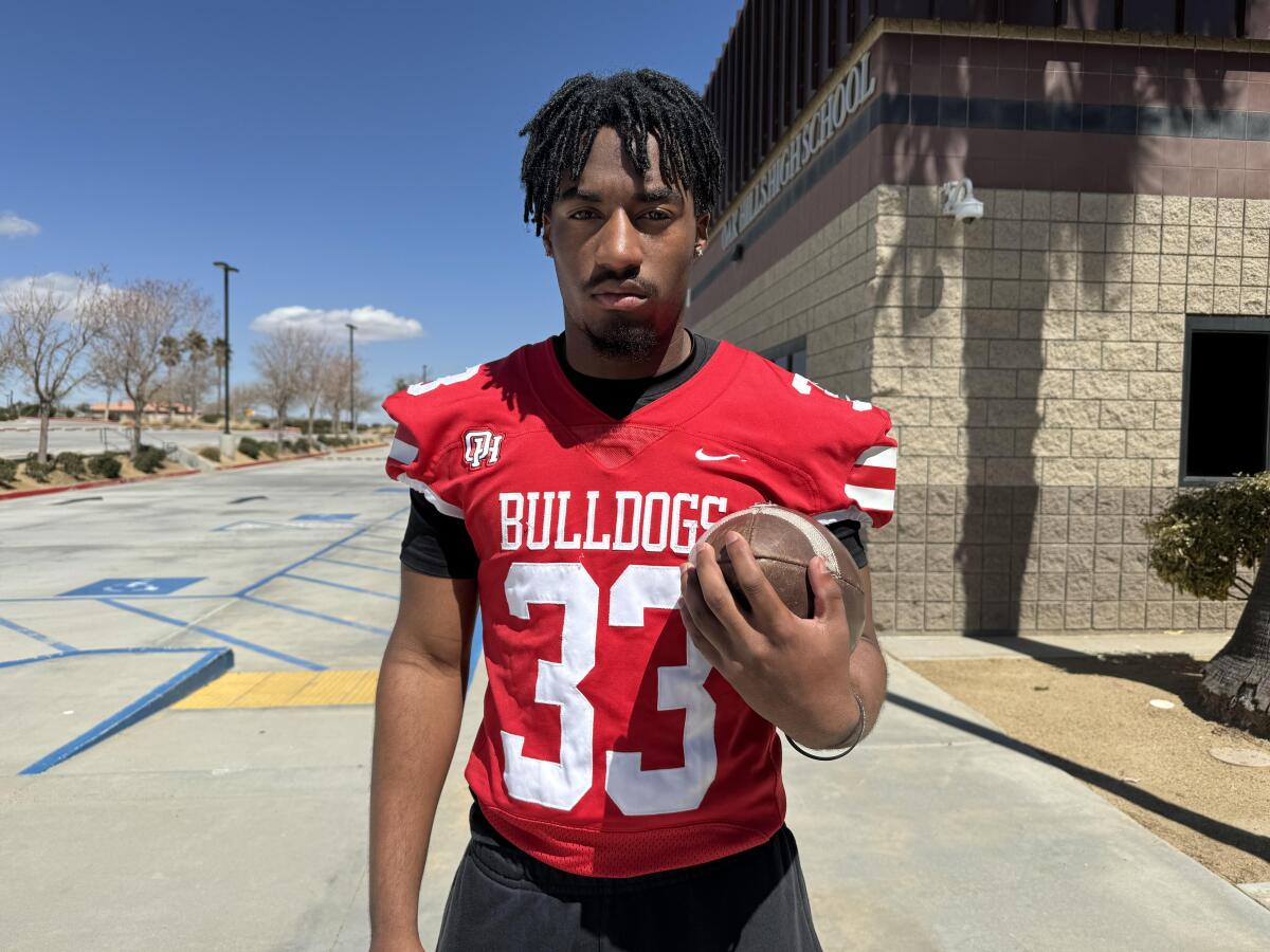 Oak Hills running back Karson Cox stands with a football.