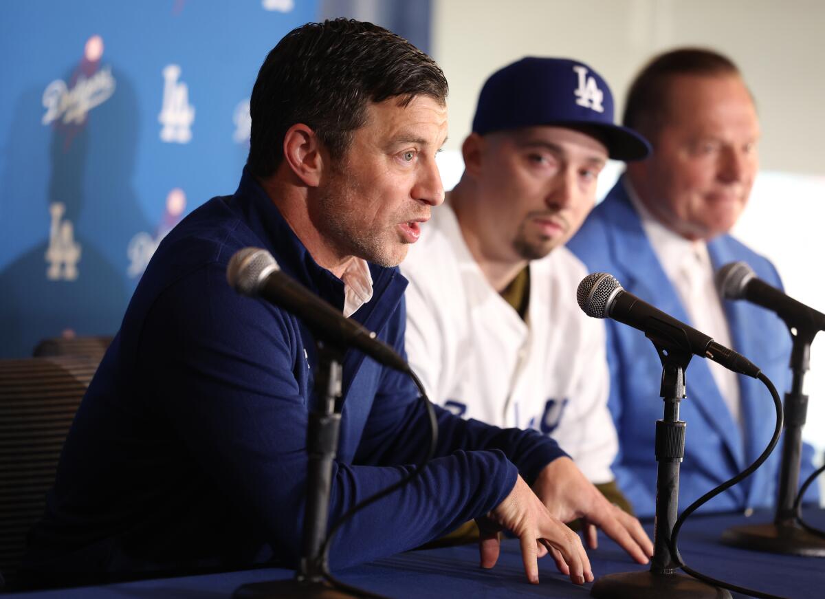 Andrew Friedman speaks while sitting next to pitcher Blake Snell and agent Scott Boras at Dodger Stadium.