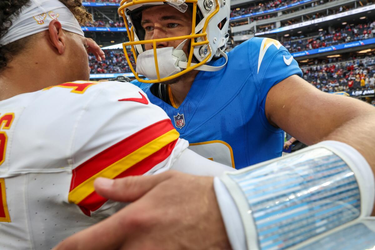 The Chargers' Justin Herbert (10) embraces Patrick Mahomes (15) after a 17-10 Chiefs win at SoFi Stadium in September.