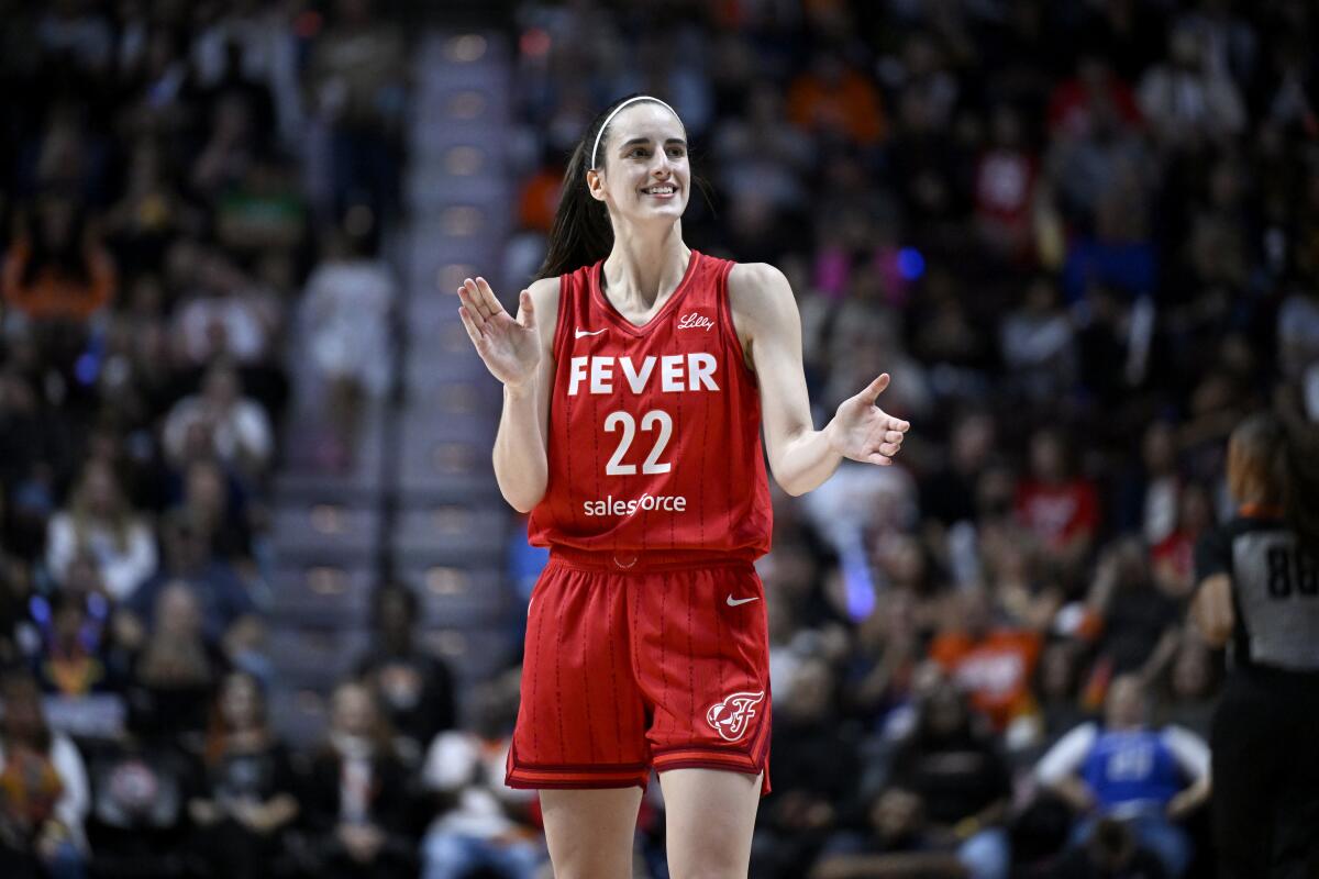 Indiana Fever guard Caitlin Clark claps during a game.