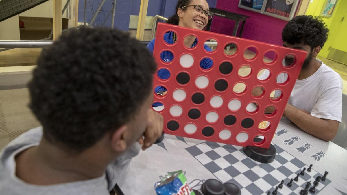 Psychology coordinator Cat Pagan, center, plays games with residents at the Sacramento County Youth Detention Facility.