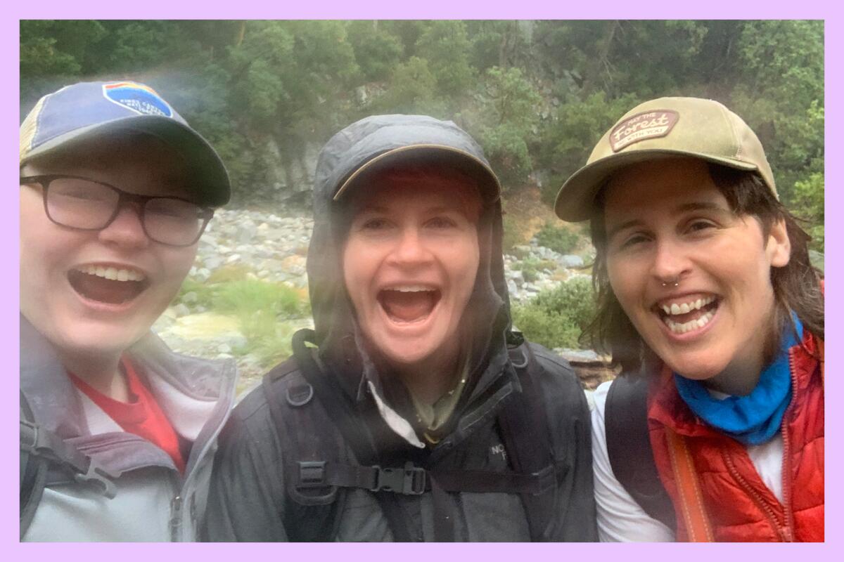 Three seemingly happy folks take a selfie during a hike.