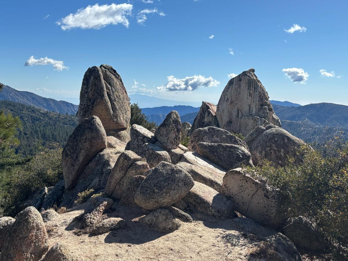 Large rocks can be seen at the top of a mountain.