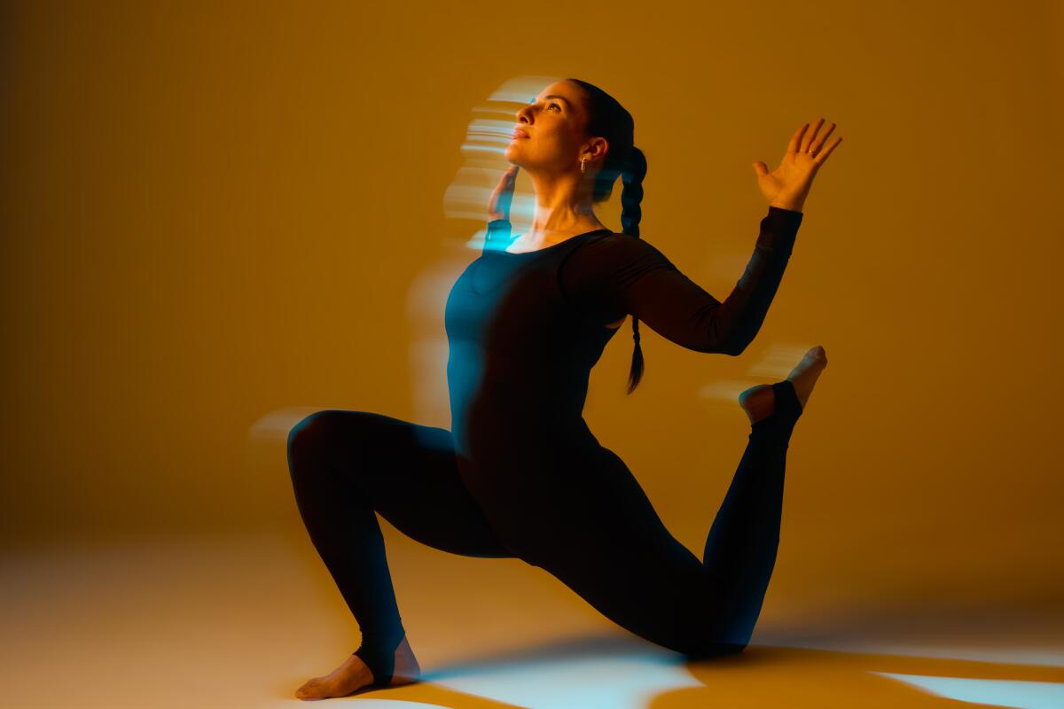 A woman holds a yoga pose.