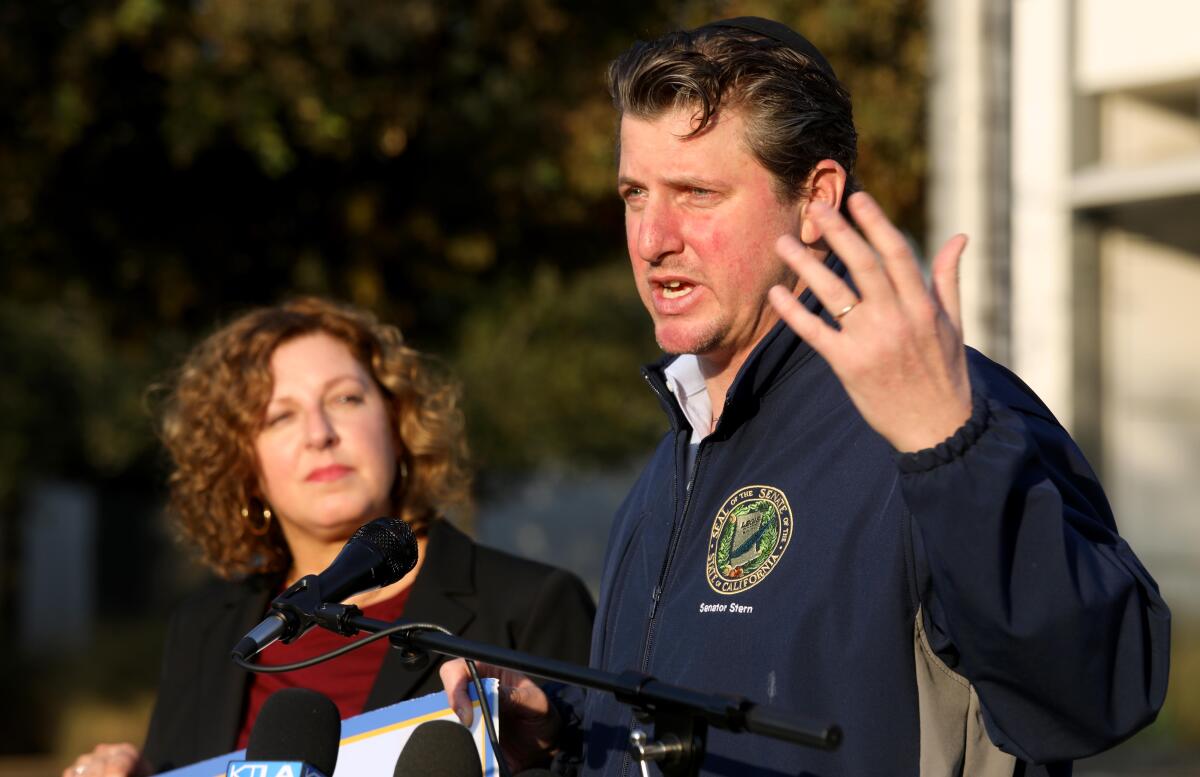 California Assemblymember Pilar Schiavo listens as California Senator Henry Stern speaks.