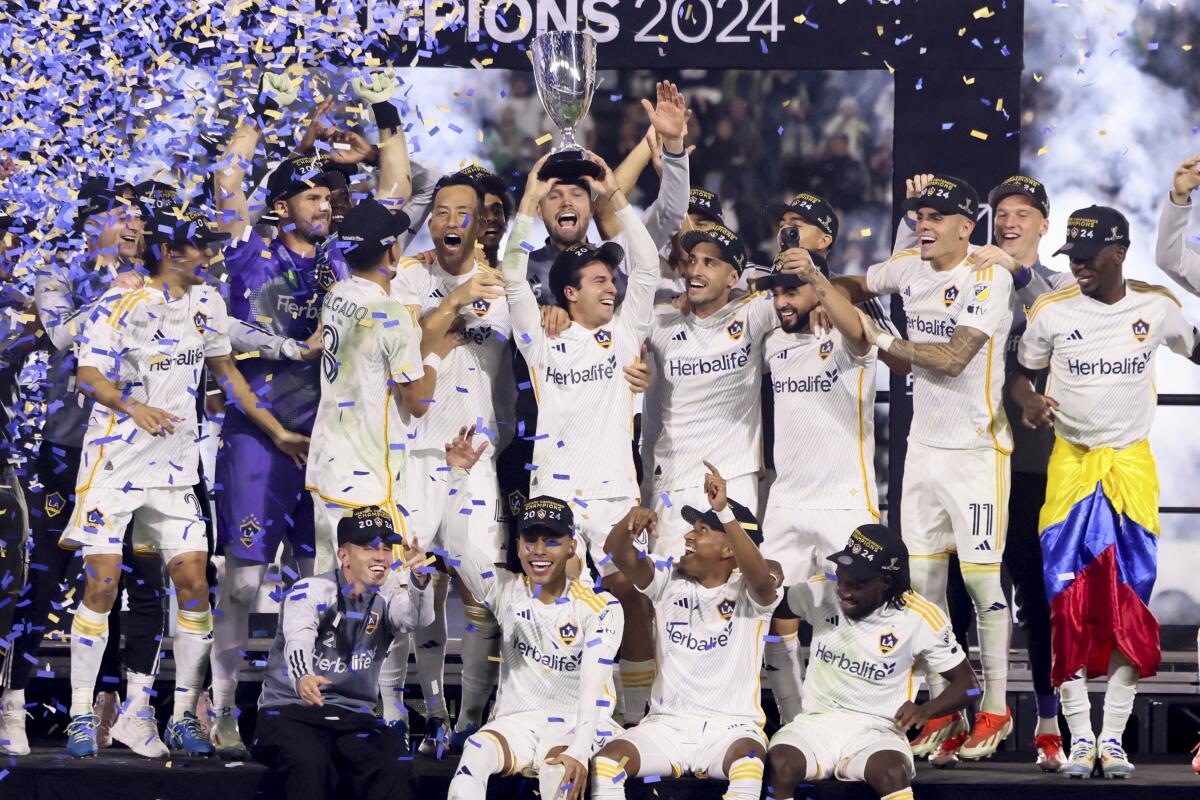 Galaxy players celebrate on the podium after a win over the Seattle Sounders in the Western Conference final 