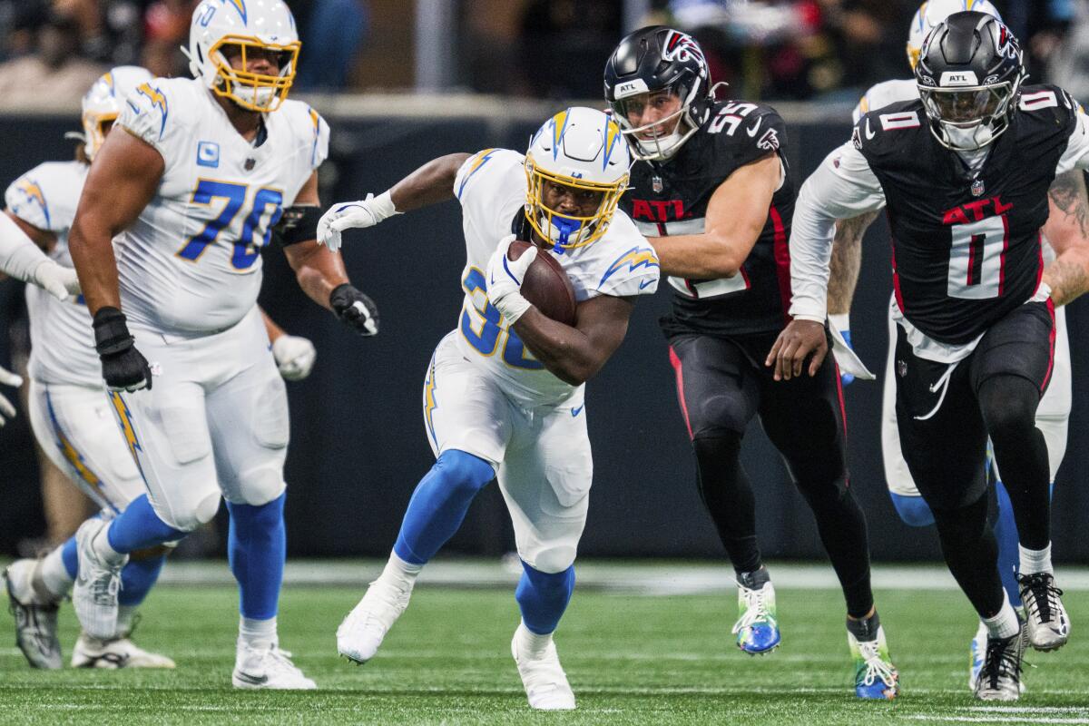 The Chargers' Kimani Vidal (30) finds running room against the Falcons.