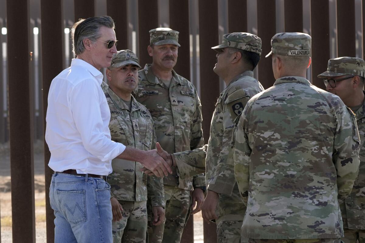 California Gov. Gavin Newsom greets members of the California National Guard near the Otay Mesa Port of Entry