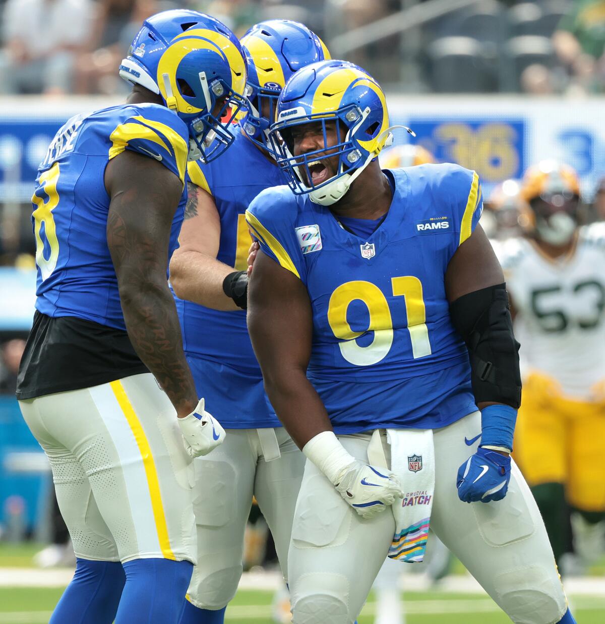 Rams defensive end Kobie Turner (91) celebrates his sack with Jared Verse.