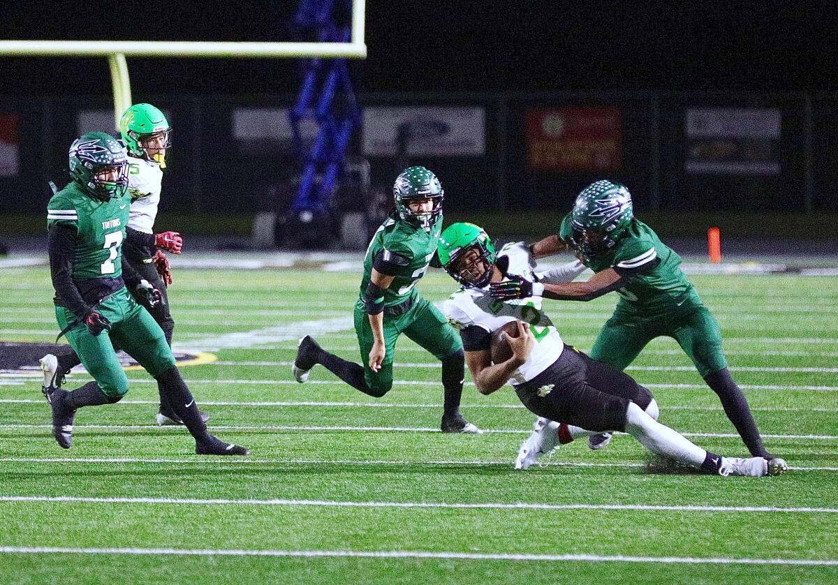 Narbonne quarterback Jaden O’Neal is sacked in the first half of the Division 2-AA regional bowl game Friday in Oxnard.