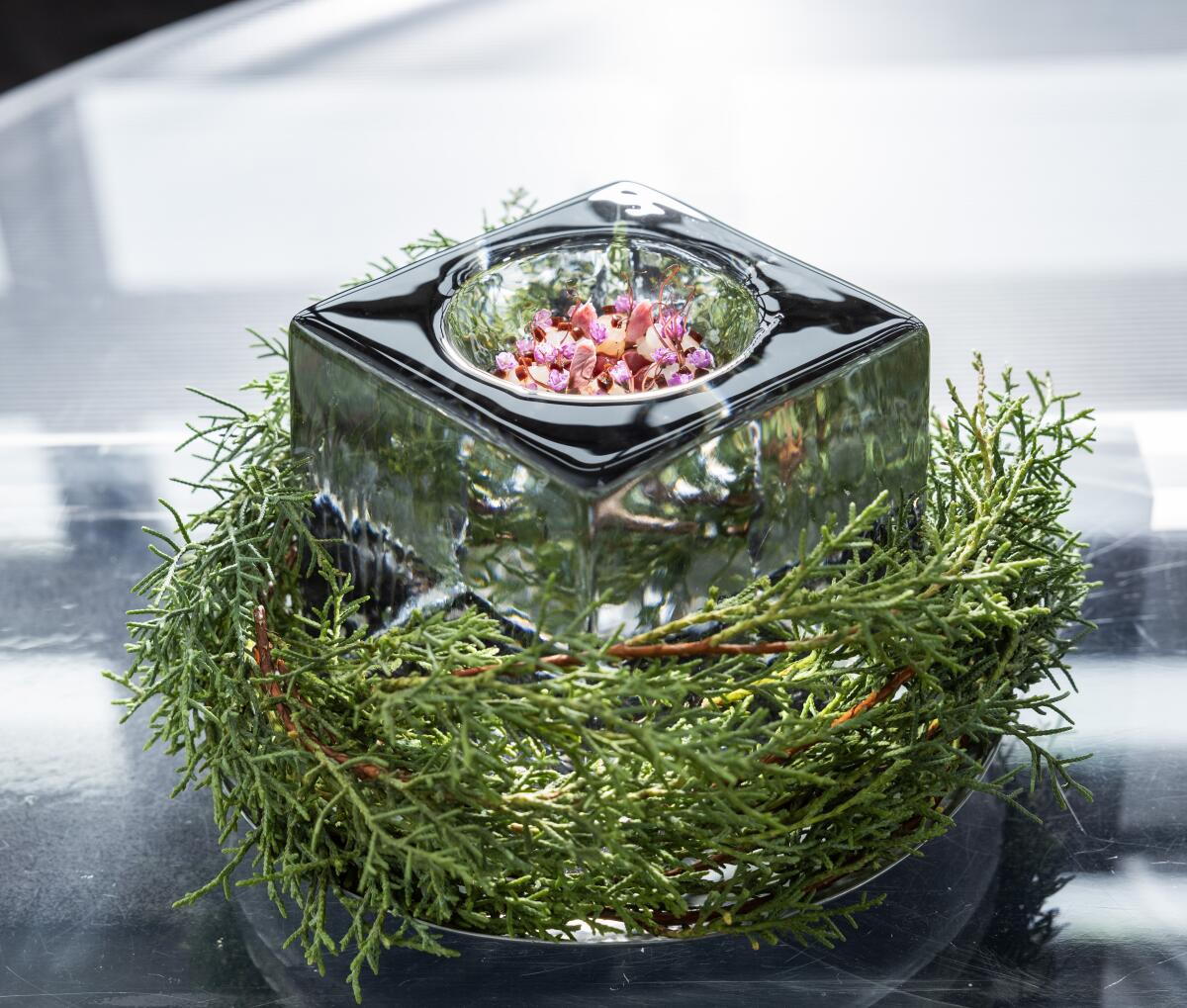 The dish called Deep Ocean, served in a block of ice sitting on a bed of fir tree twigs.