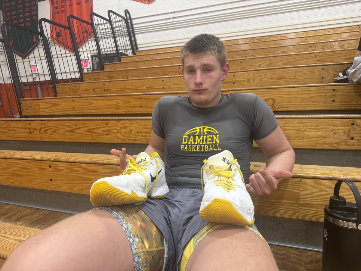 Damien 7-footer Nate Garcia with his size 21 shoes.