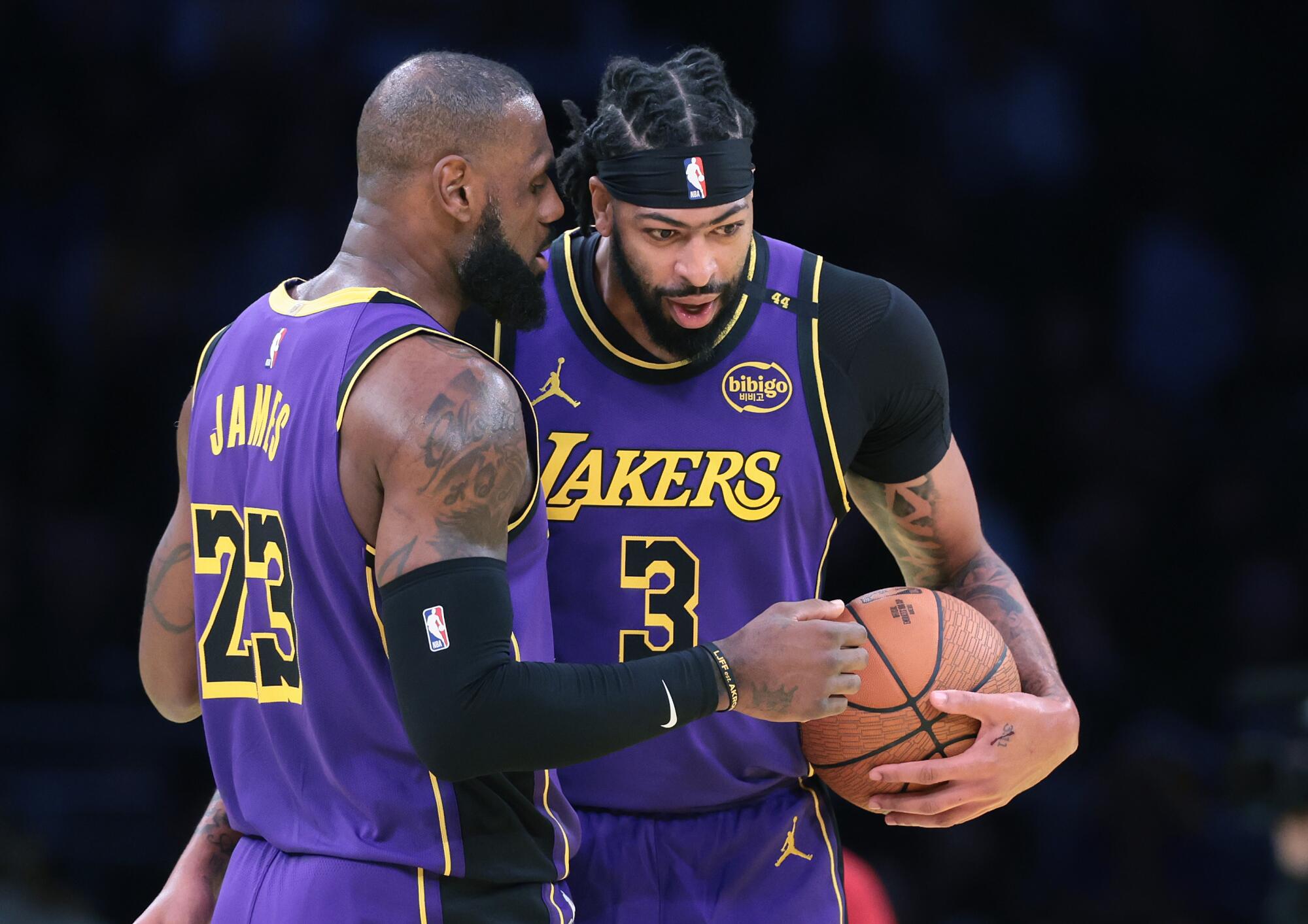 Lakers star LeBron James, left, talks to Anthony Davis during a win over the Utah Jazz on Nov. 19.