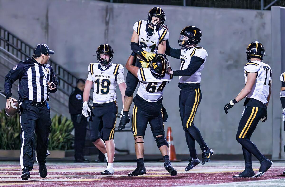 Record-setting receiver Shane Rosenthal of Newbury Park is lifted up by teammate Joel Gonzalez.