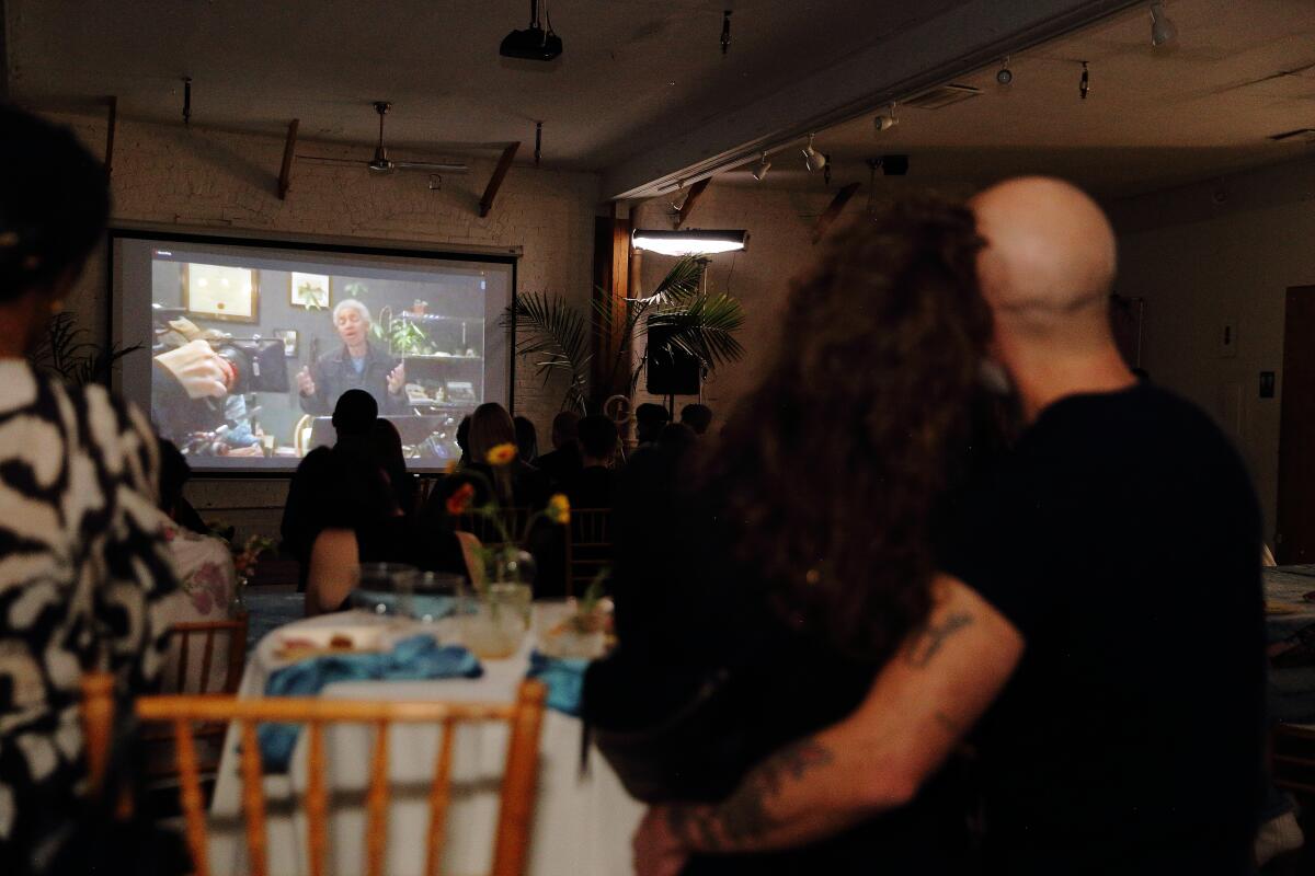 A crowd watches Beverly Glenn-Copeland and his wife, Elizabeth, perform virtually from their home in Hamilton, Canada