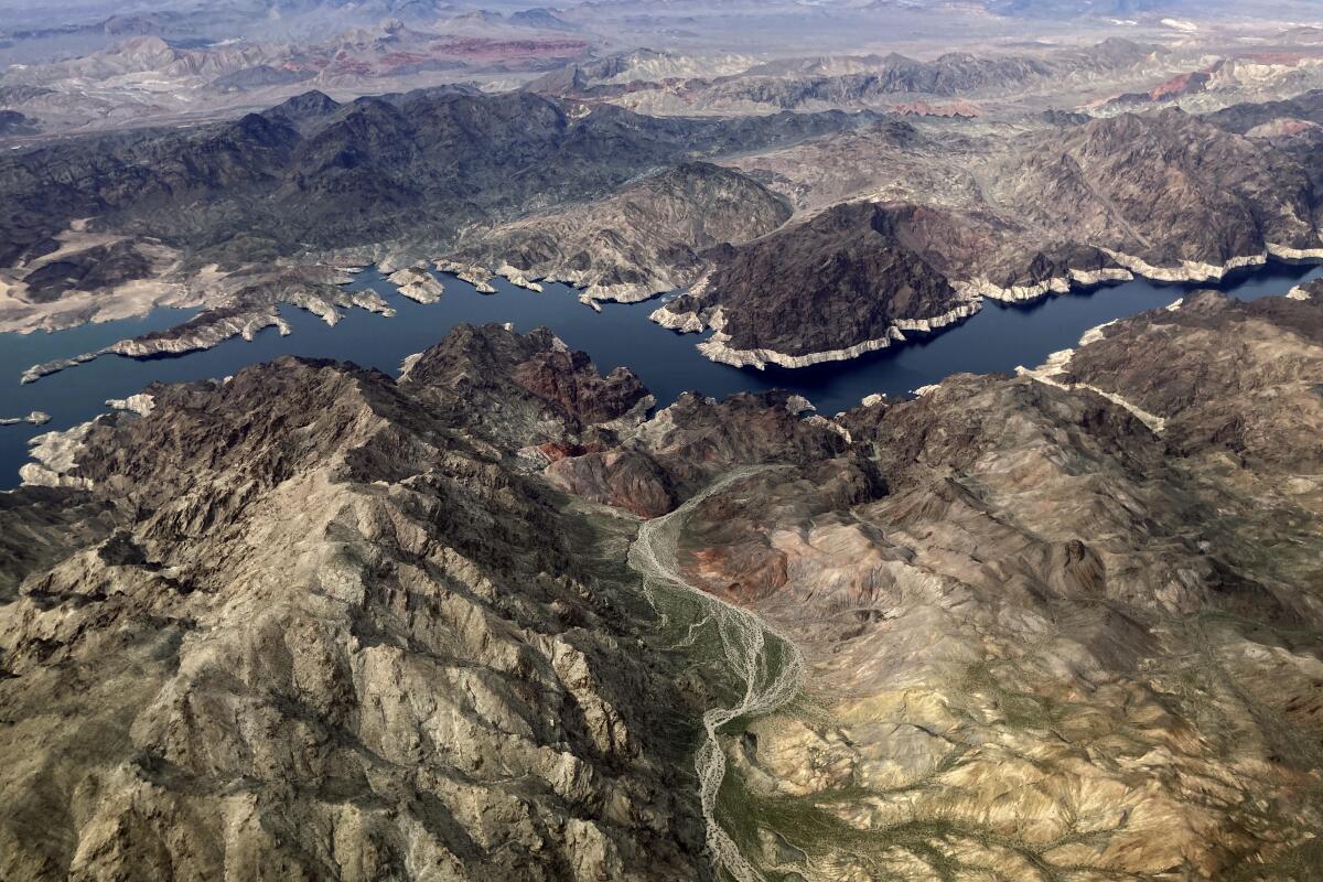 A "bathtub ring" of minerals shows the high water mark on the shore of Lake Mead, near Boulder City, Nev., in 2023.