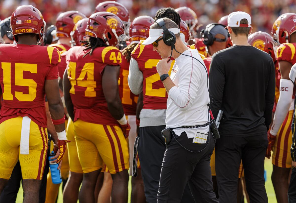 USC coach Lincoln Riley walks behind his starters during a timeout against Notre Dame at the Coliseum on Nov. 30.